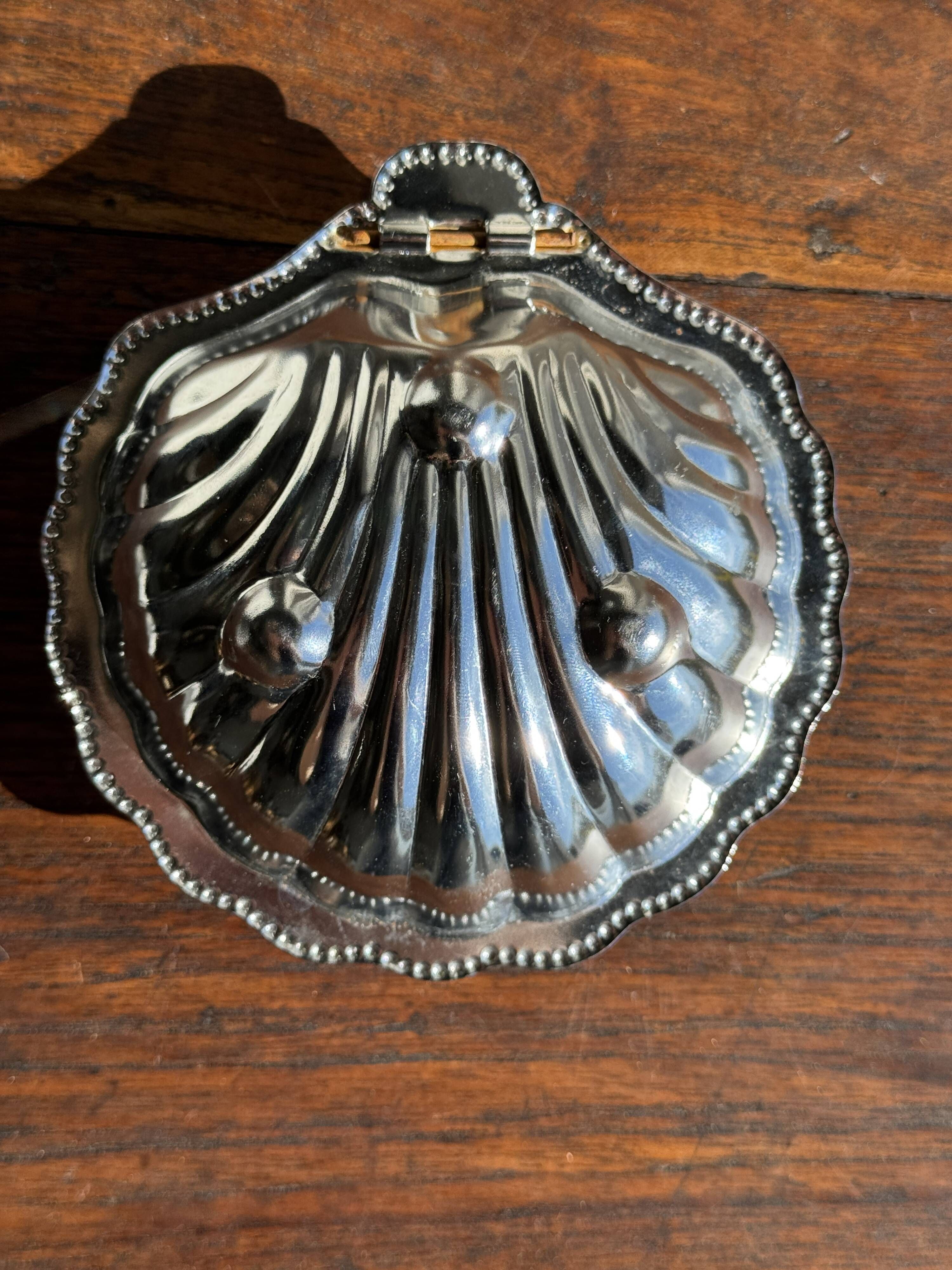 Vintage silver-plated shell butter dish with transparent bowl.