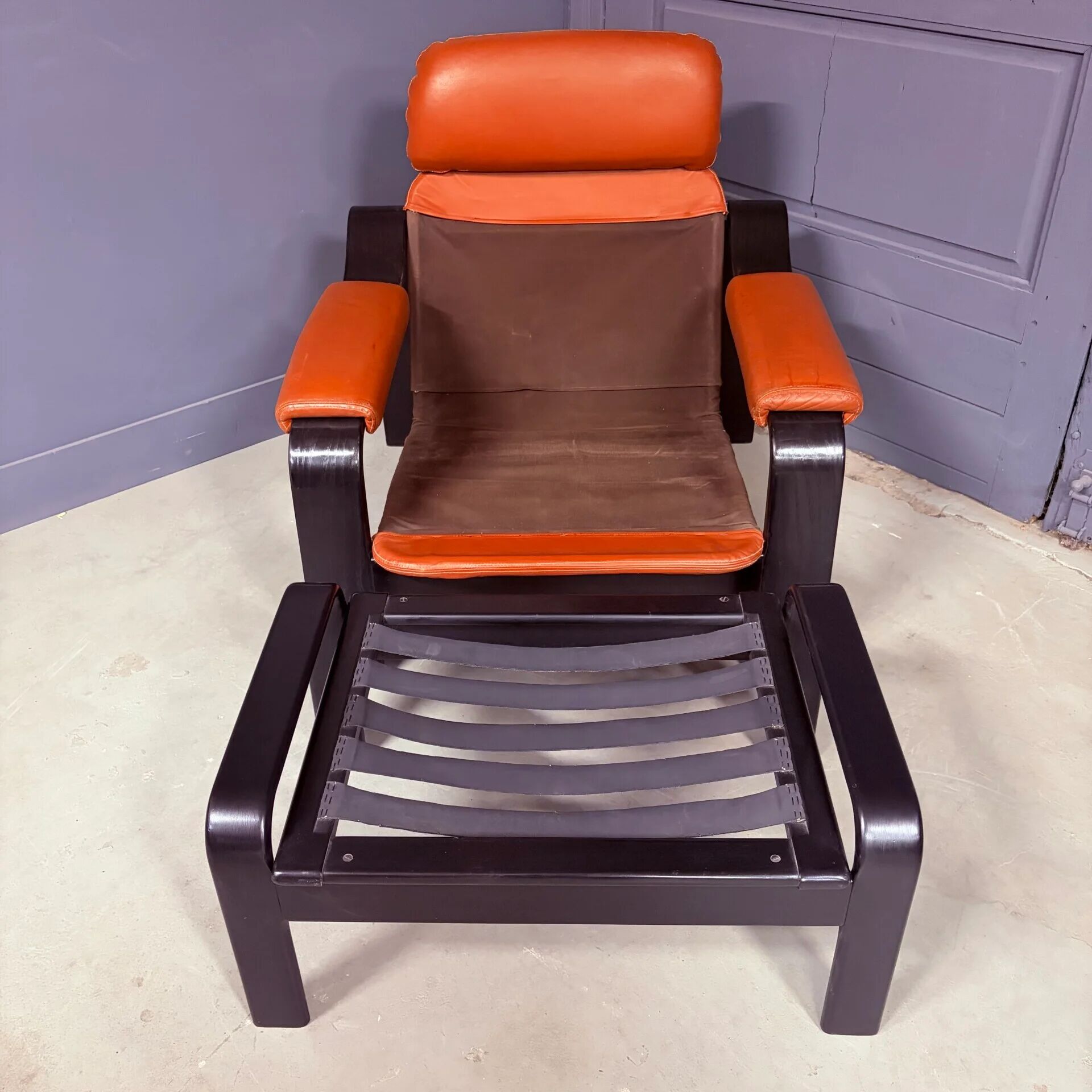 Vintage 1970s armchair with ottoman, leather and wood