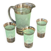 Serve an orangeade, a carafe and 3 glasses in green granite with golden trim.