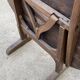 Old folding round winemaker's table with a tilting top.