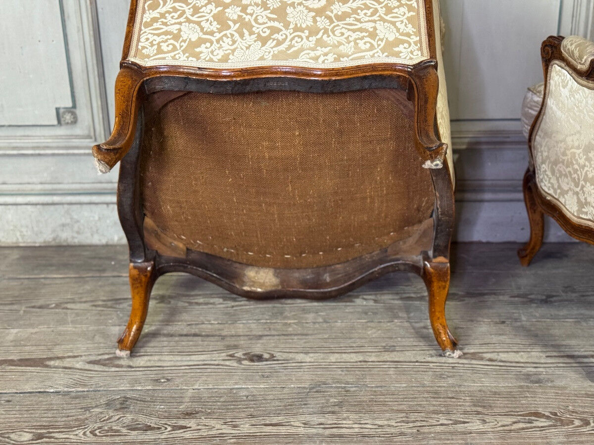 Pair of small Louis XV style wing chairs in carved walnut, Bosson stamp