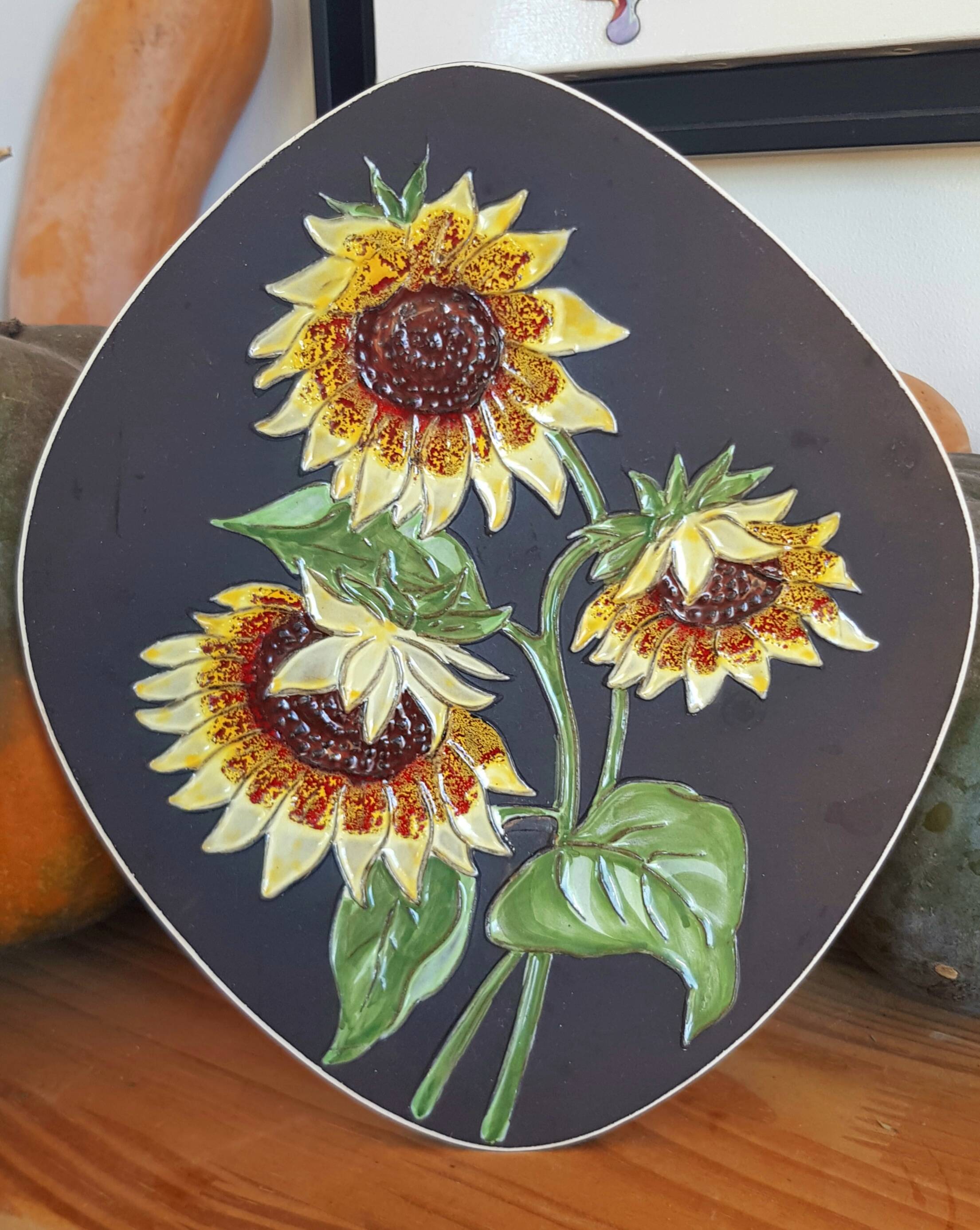 Decorative wall plate with sunflowers.