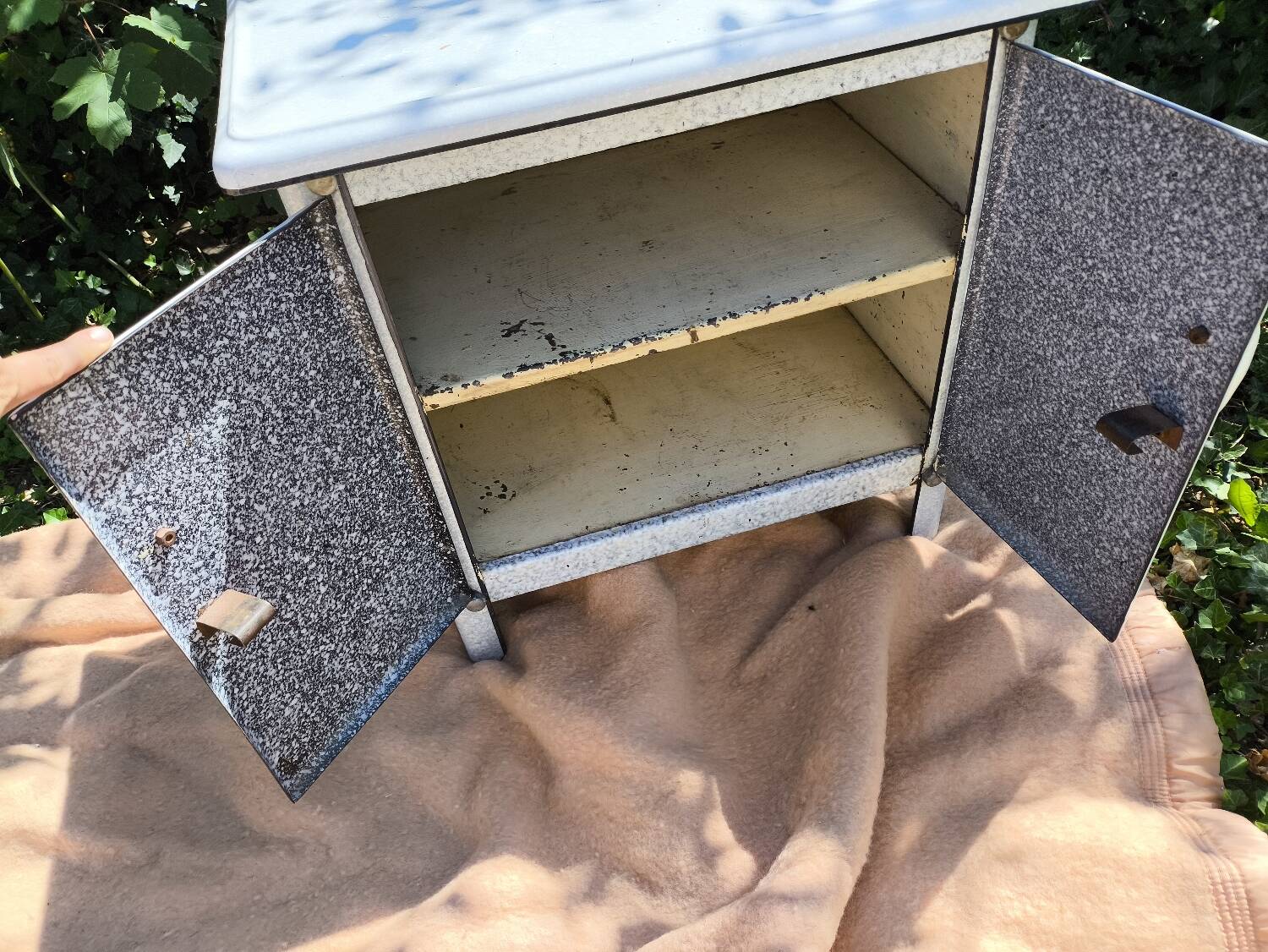 Small white and speckled gray industrial style enameled piece of furniture