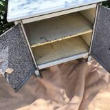 Small white and speckled gray industrial style enameled piece of furniture