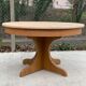 Round extendable Scandinavian dining table in Baumann style oak with central leg