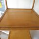 Storage column, wooden bookshelf and woven rattan.