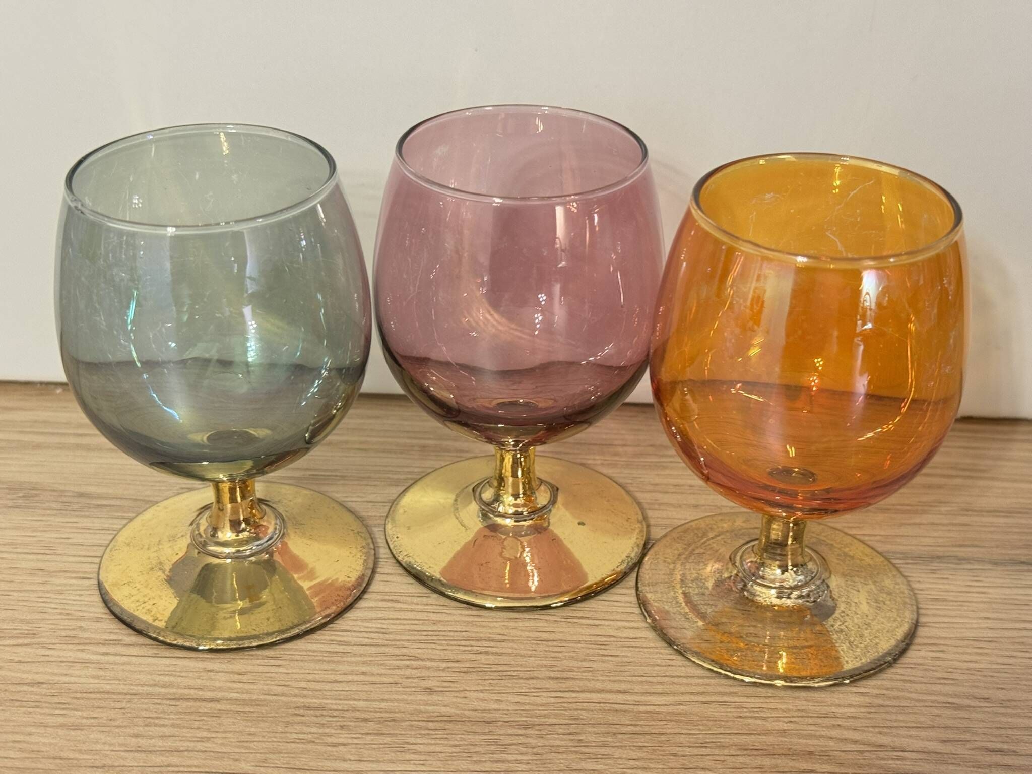 3 coloured smoked glass liqueur glasses with golden stems, vintage.