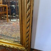 Miroir avec un ange en bois doré et stuc 166x61cm