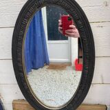 Old oval mirror with slate-coloured patina