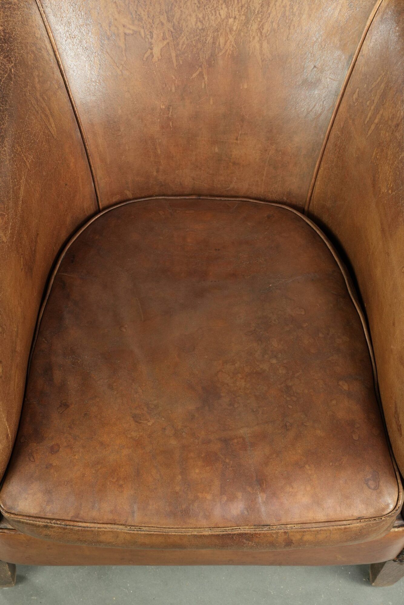 Vintage sheepskin club armchair finished with decorative nails