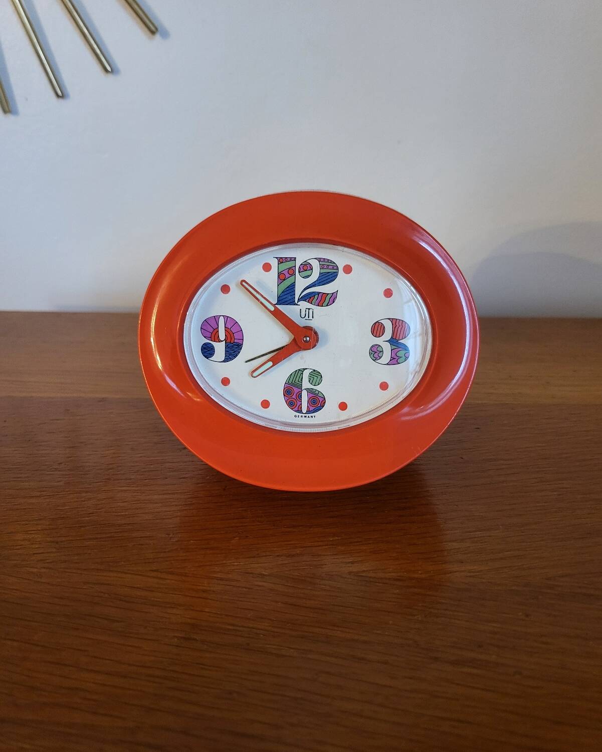 Vintage mechanical alarm clock in orange plastic Uti West Germany
