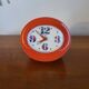 Vintage mechanical alarm clock in orange plastic Uti West Germany