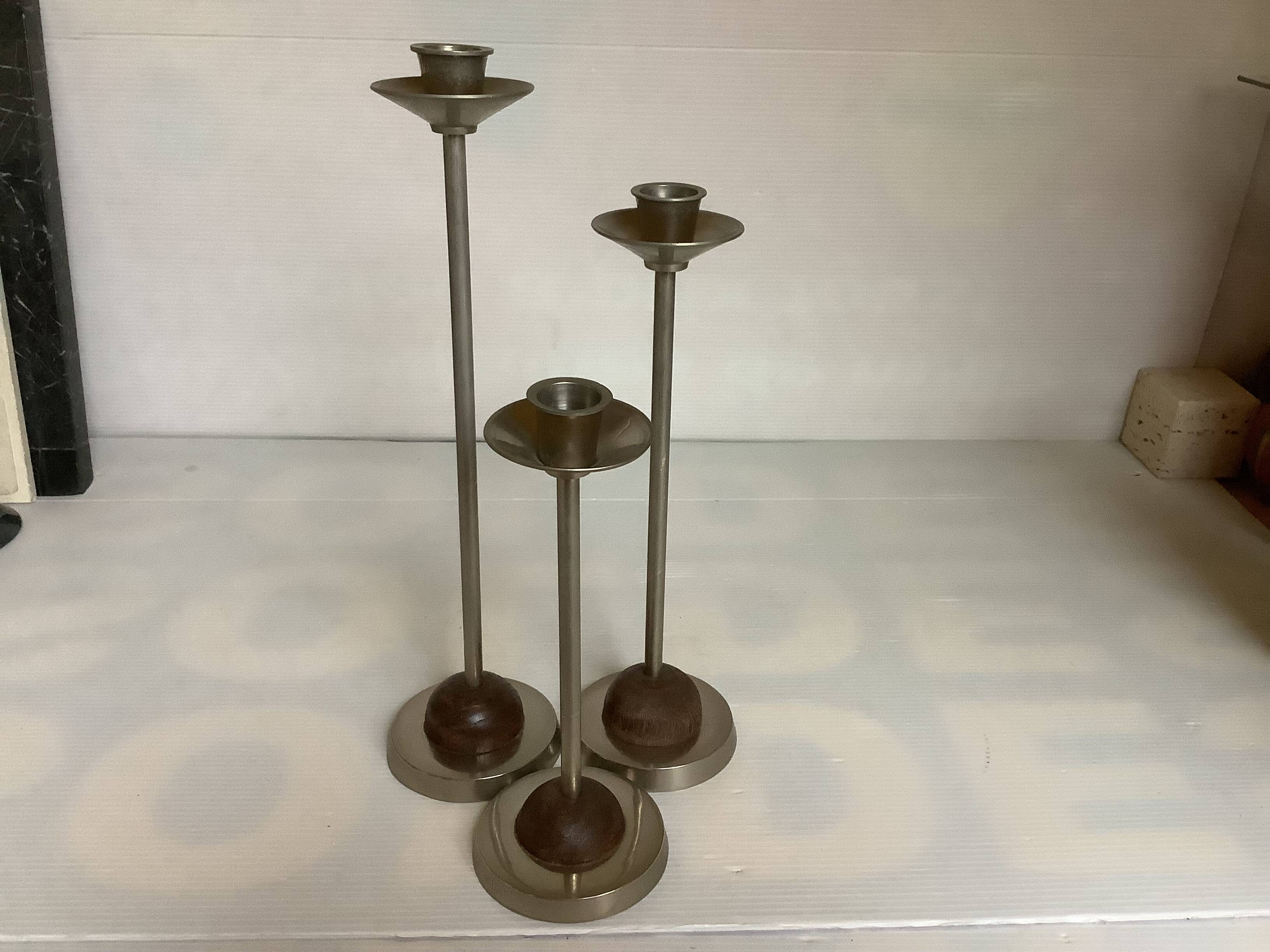 Trio of metal and wood candlesticks