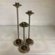 Trio of metal and wood candlesticks