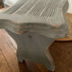 Small footrest bench in solid wood with a slate grey patina.