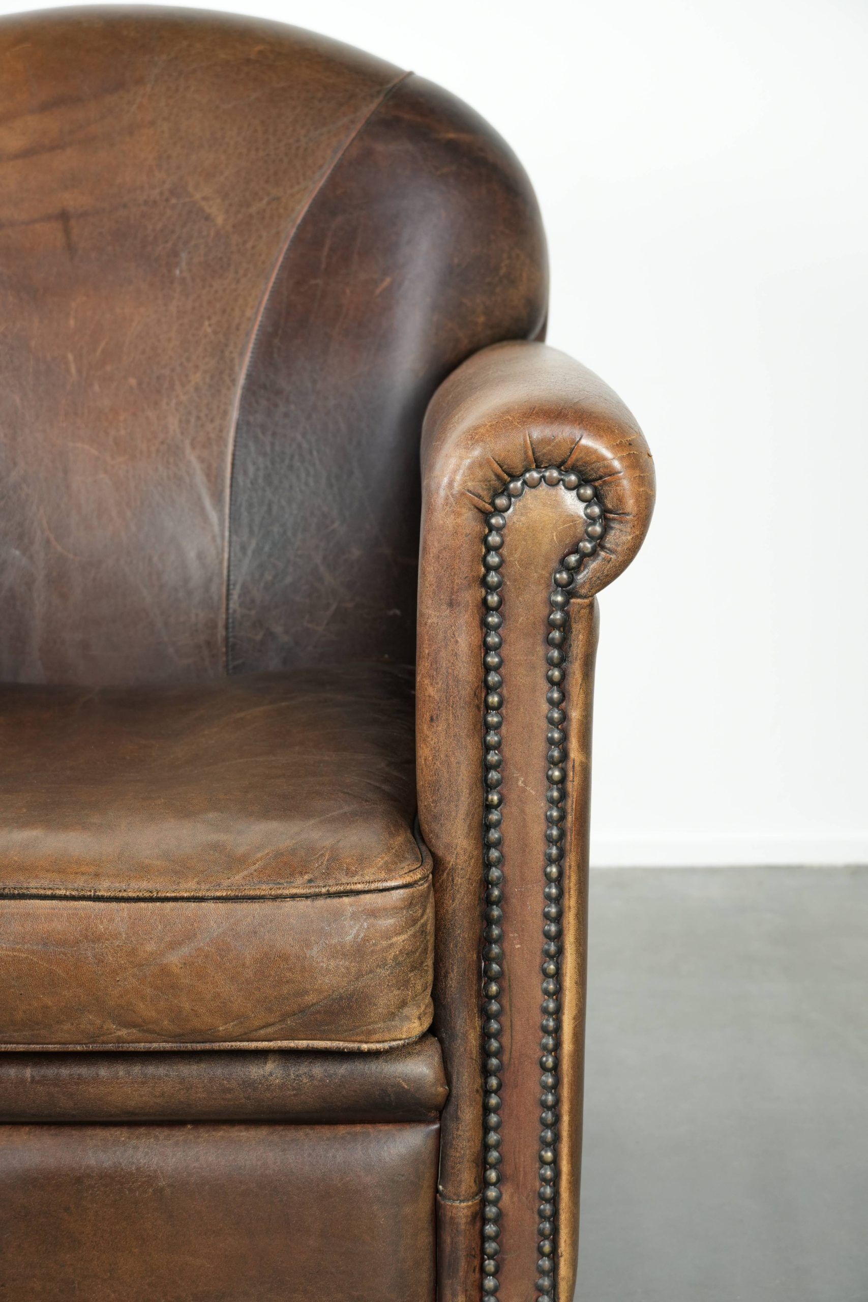Armchair / lounge chair made of sheepskin leather with characterful patina