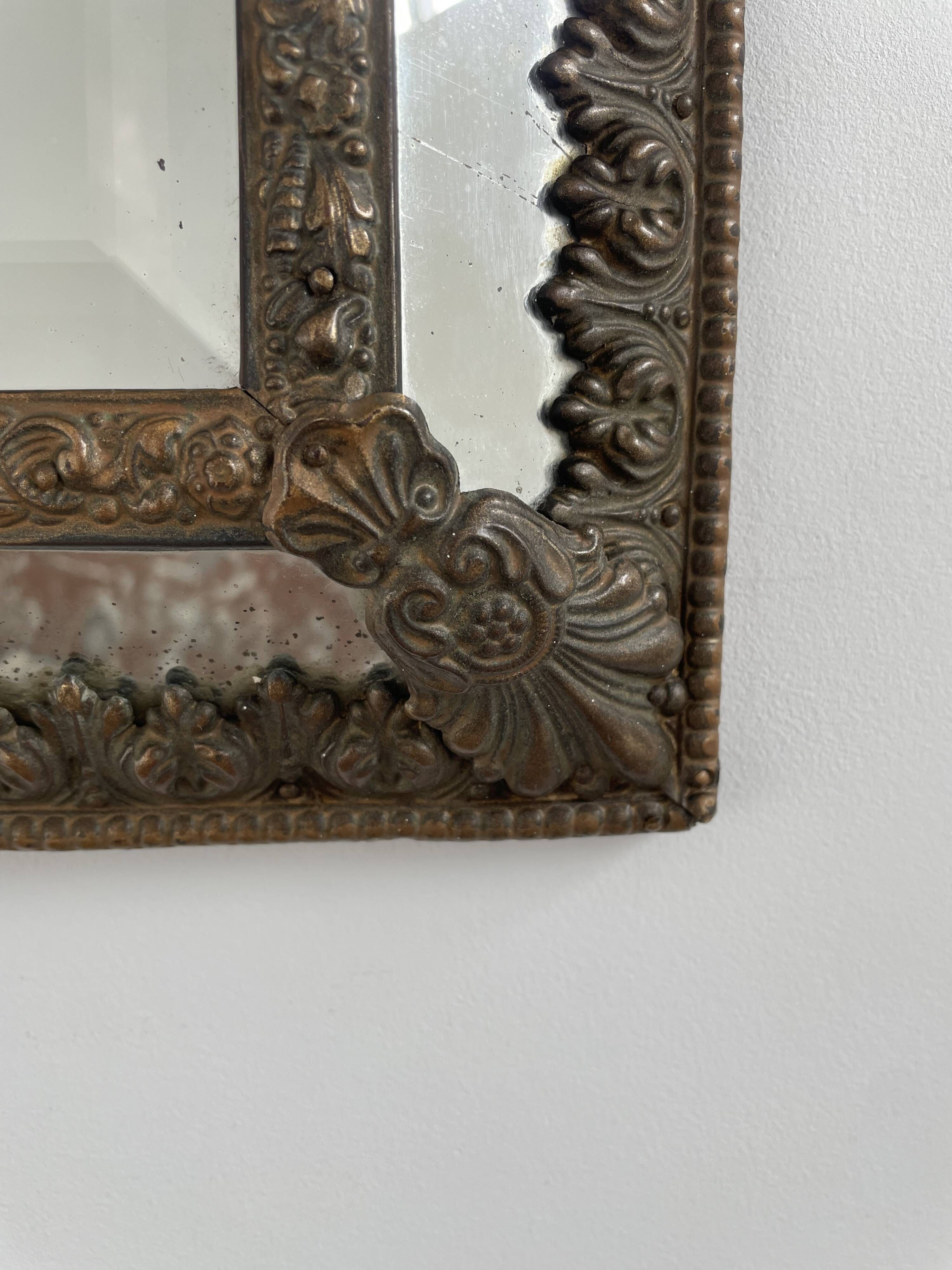Small mirror with brass parcloses in repoussé style Louis XIV, late 19th century.