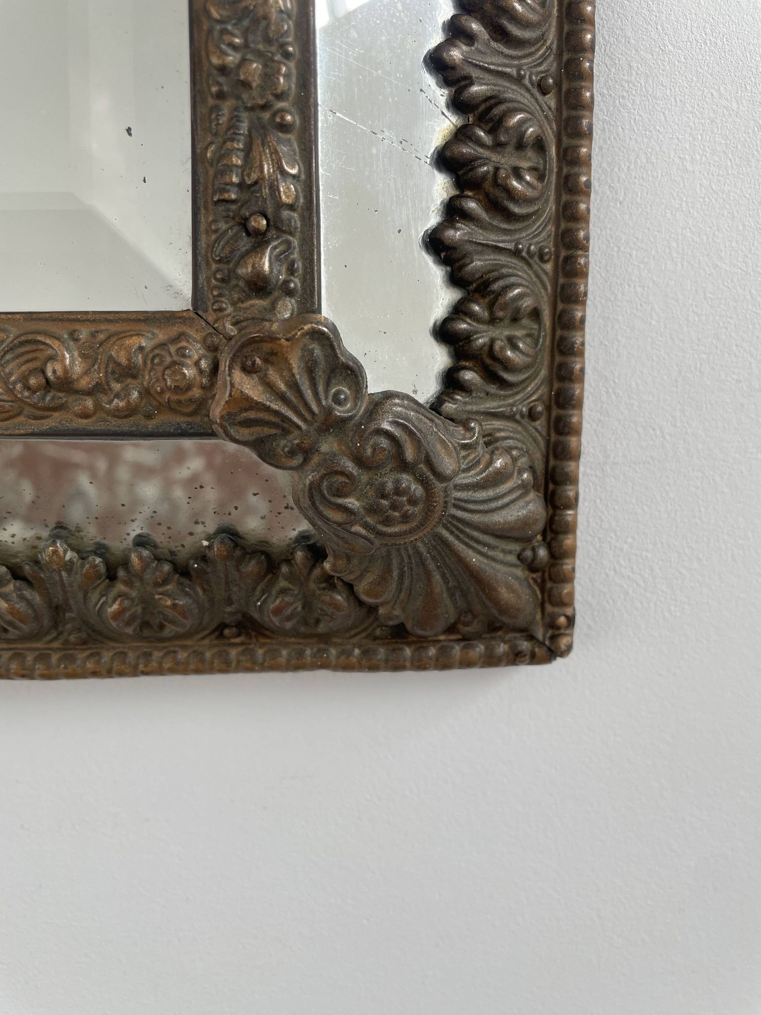Small mirror with brass parcloses in repoussé style Louis XIV, late 19th century.