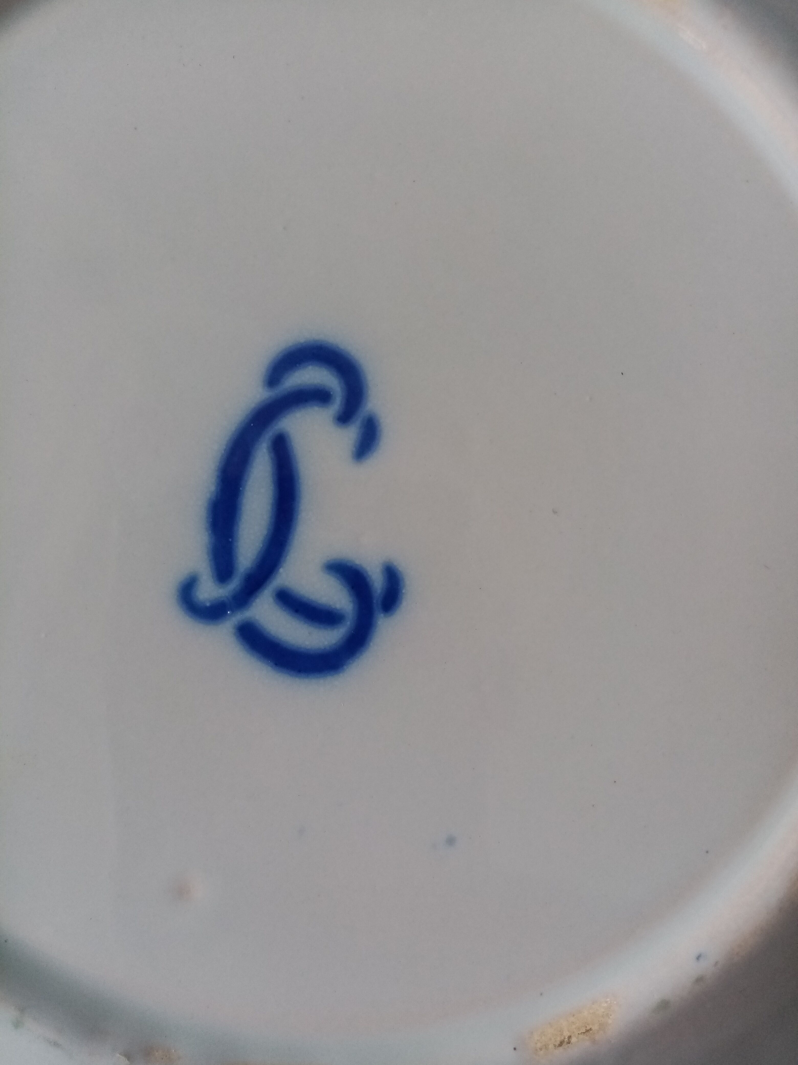 18th century earthenware decorative plate signed Saint Clement with royal coat of arms decoration