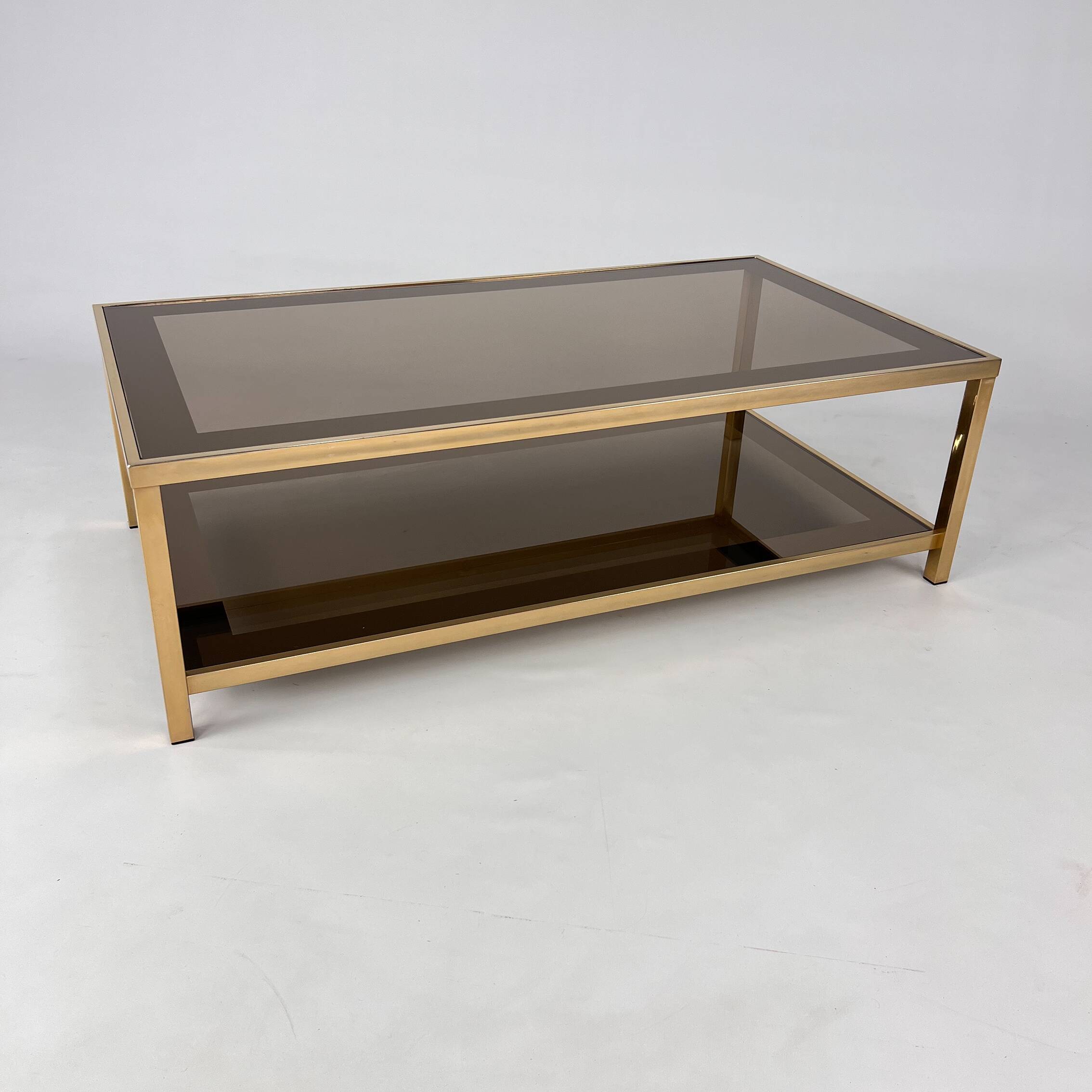 Belgo Chrome coffee table in brass and smoked mirror glass, 1970s.