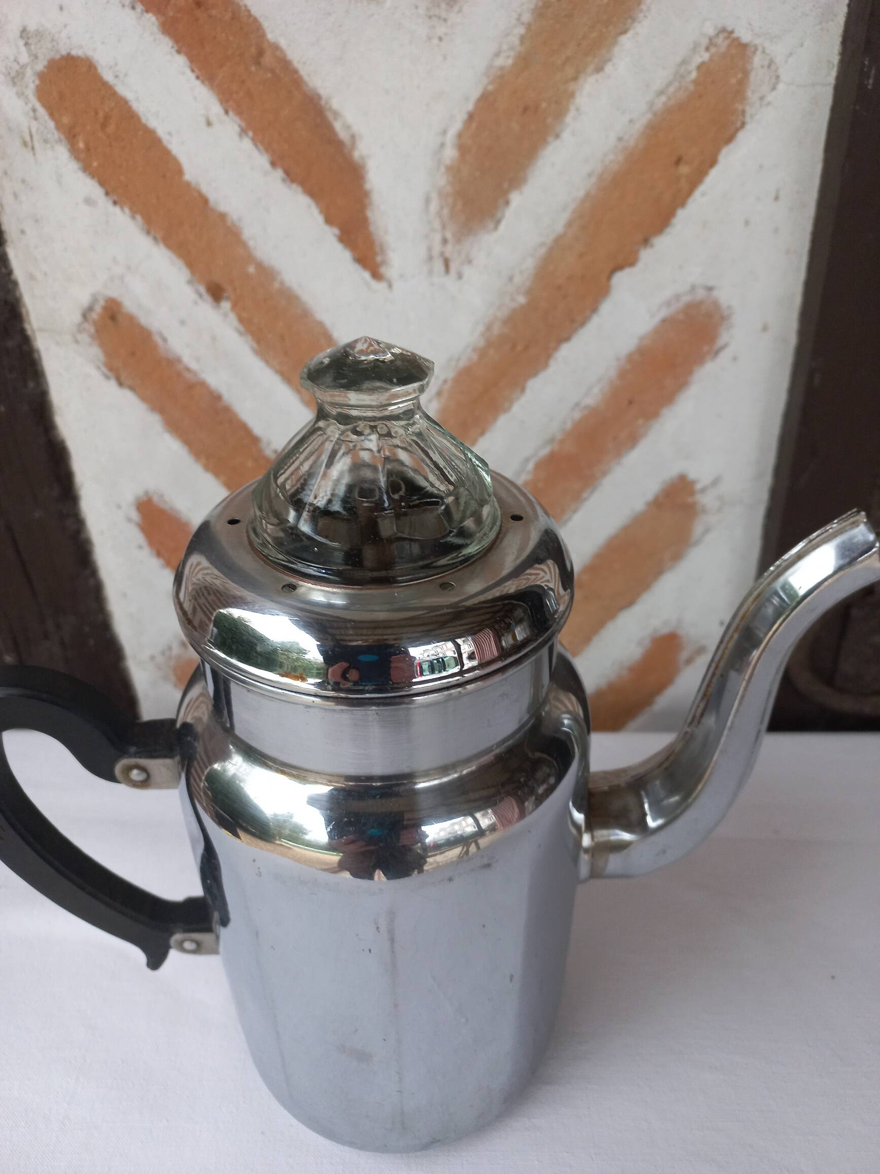 Silver metal coffee maker with glass cap