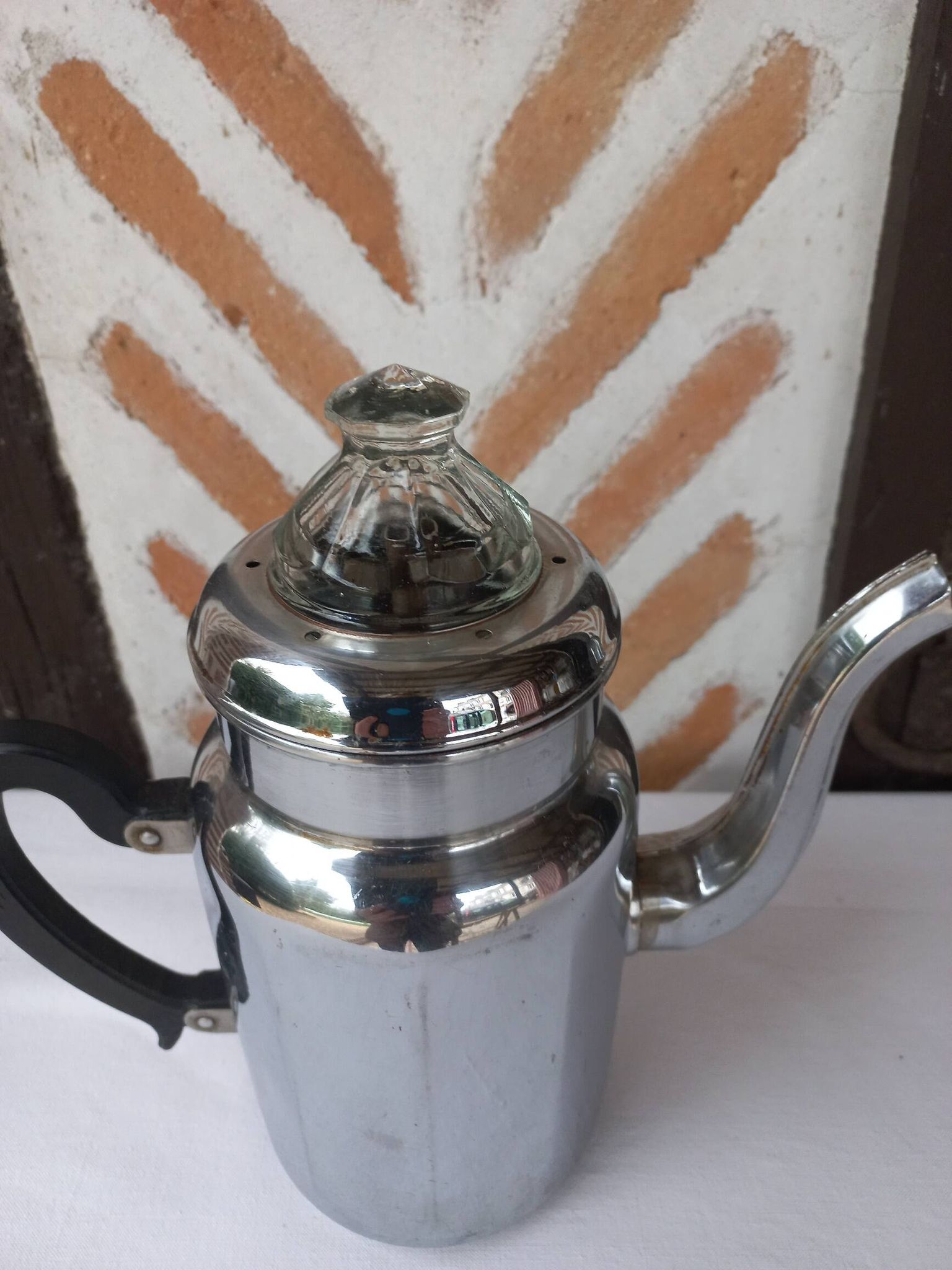 Silver metal coffee maker with glass cap