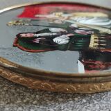Old round box with decoration fixed under glass