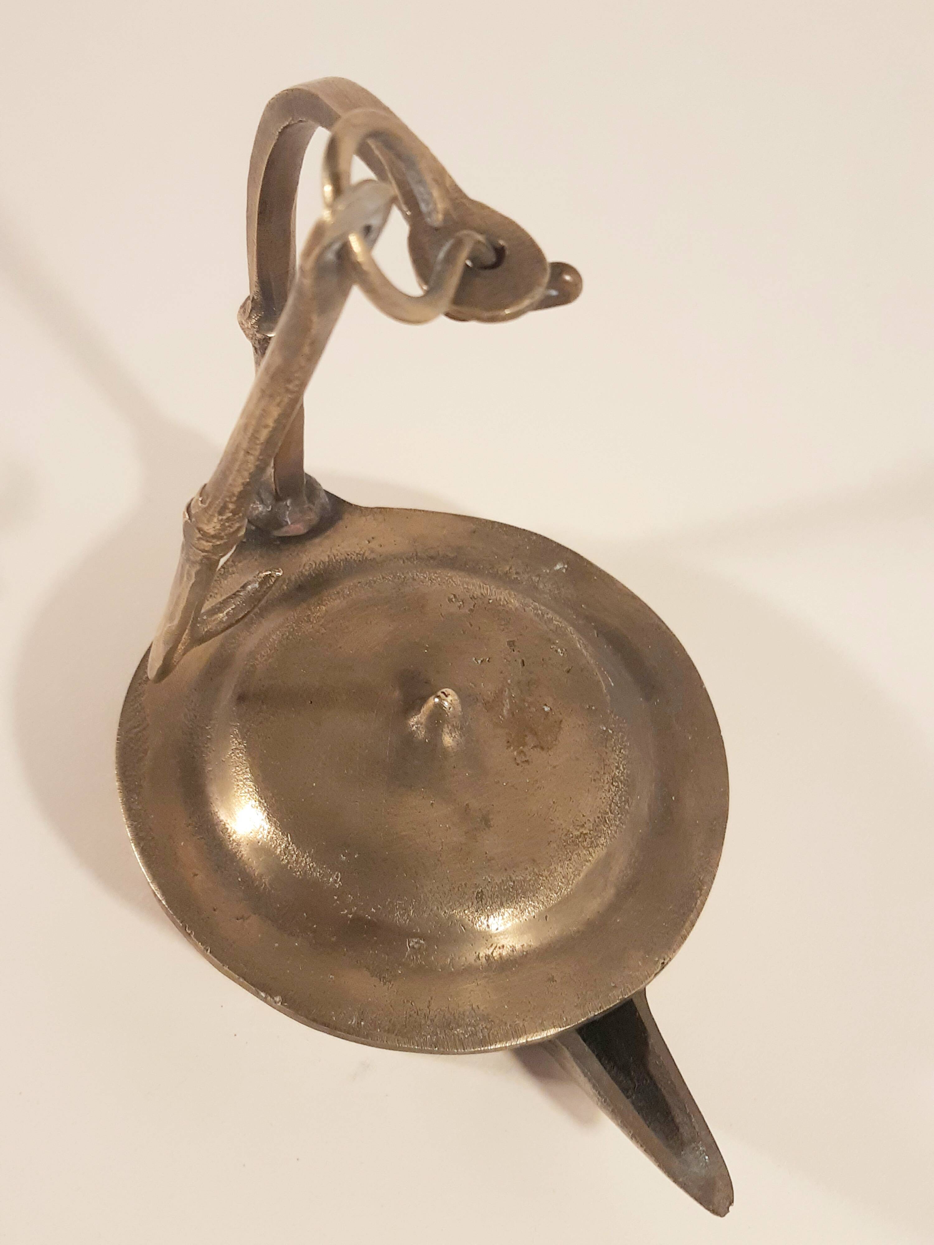 Old oil lamp in golden brass to hang