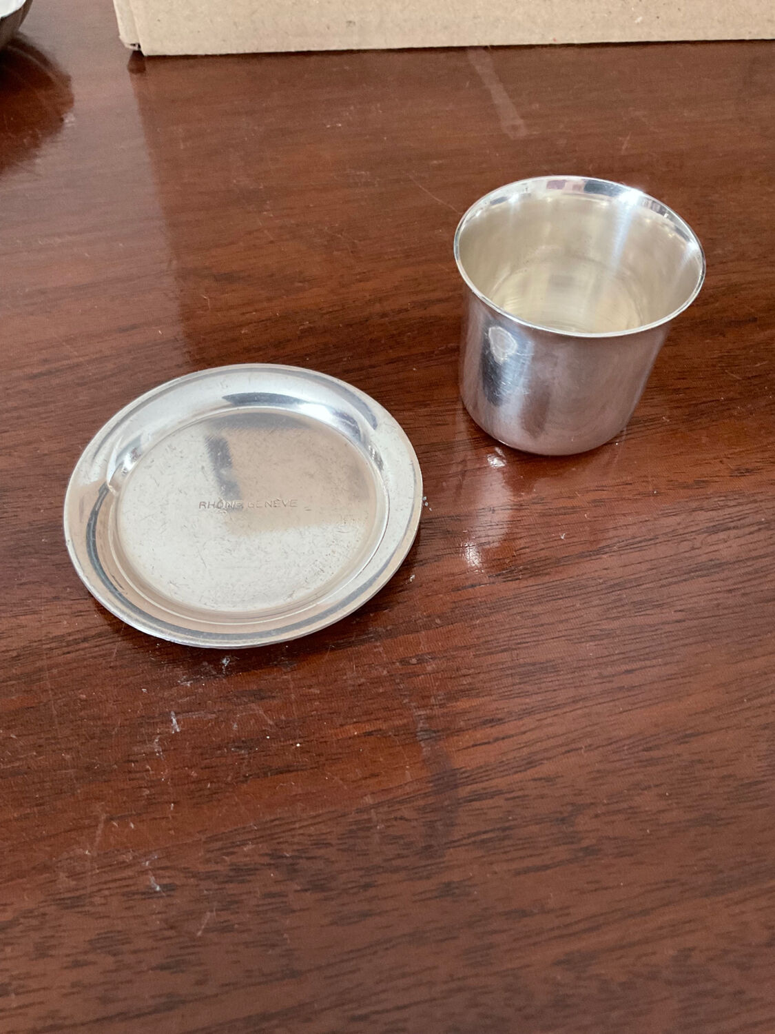 Cup and silver metal saucer