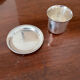 Cup and silver metal saucer