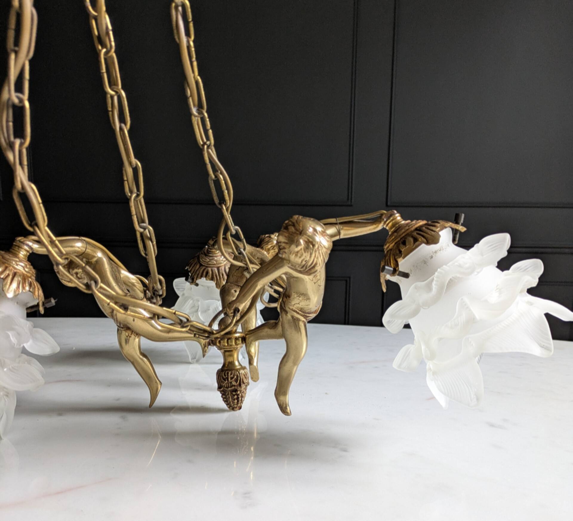 Vintage chandelier with cherubs and frosted glass flowers.