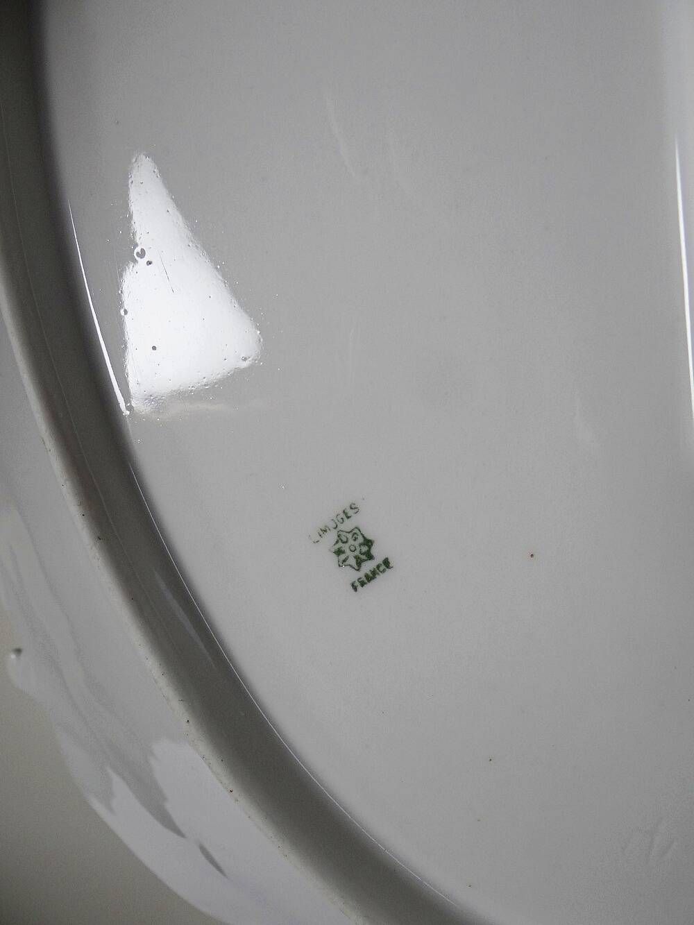 Antique deep dish in white Limoges porcelain, with rockwork relief.
