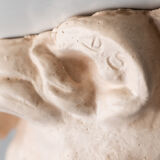 Lion's head in painted plaster