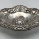 Silver-plated metal pocket emptier with openwork outline decoration