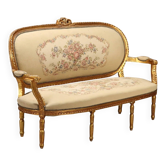Neoclassical canapé in gilded wood