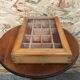 Old hanging display case with 15 wooden boxes, red background + vintage glass door