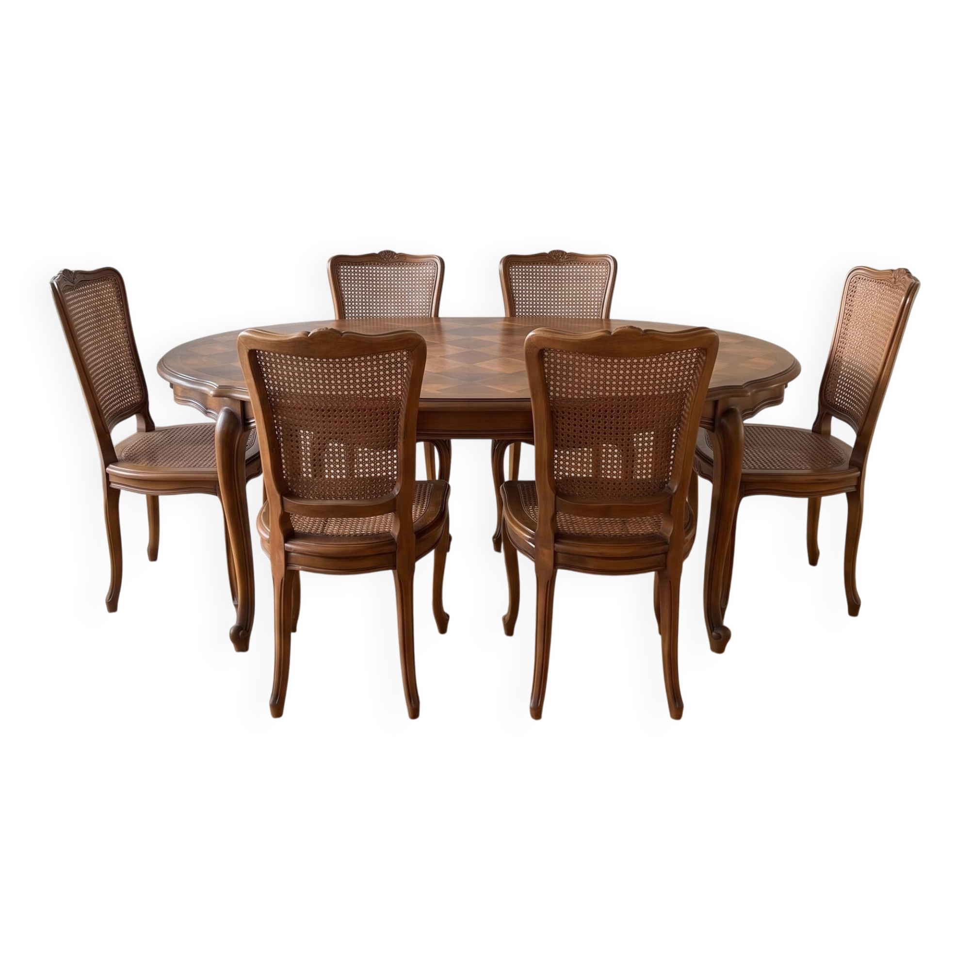 Oval dining table and 6 caned chairs in Louis XVI style made of wood.