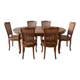 Oval dining table and 6 caned chairs in Louis XVI style made of wood.