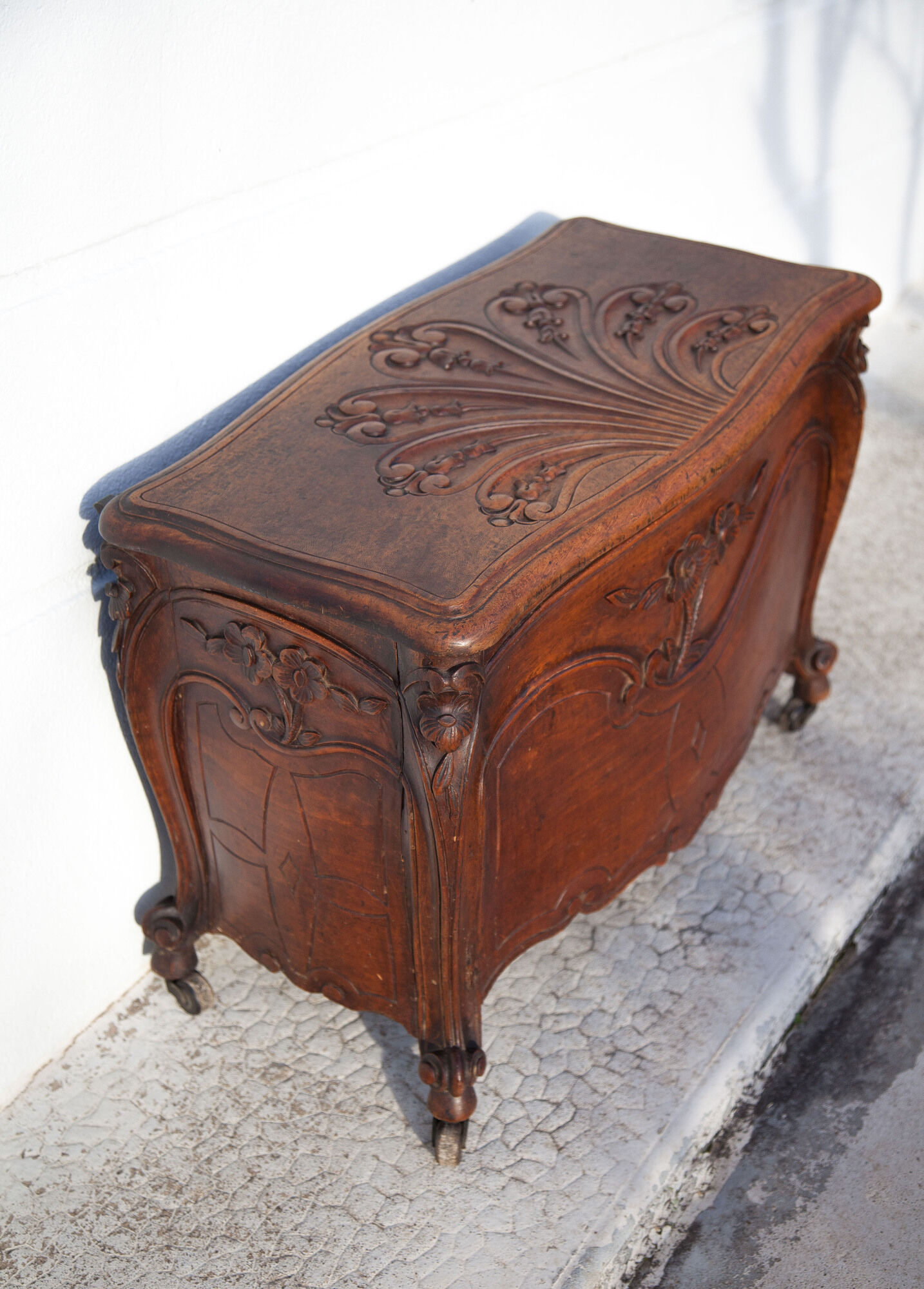 Old chest, carved wooden chest, curved chest on wheels, interior decoration