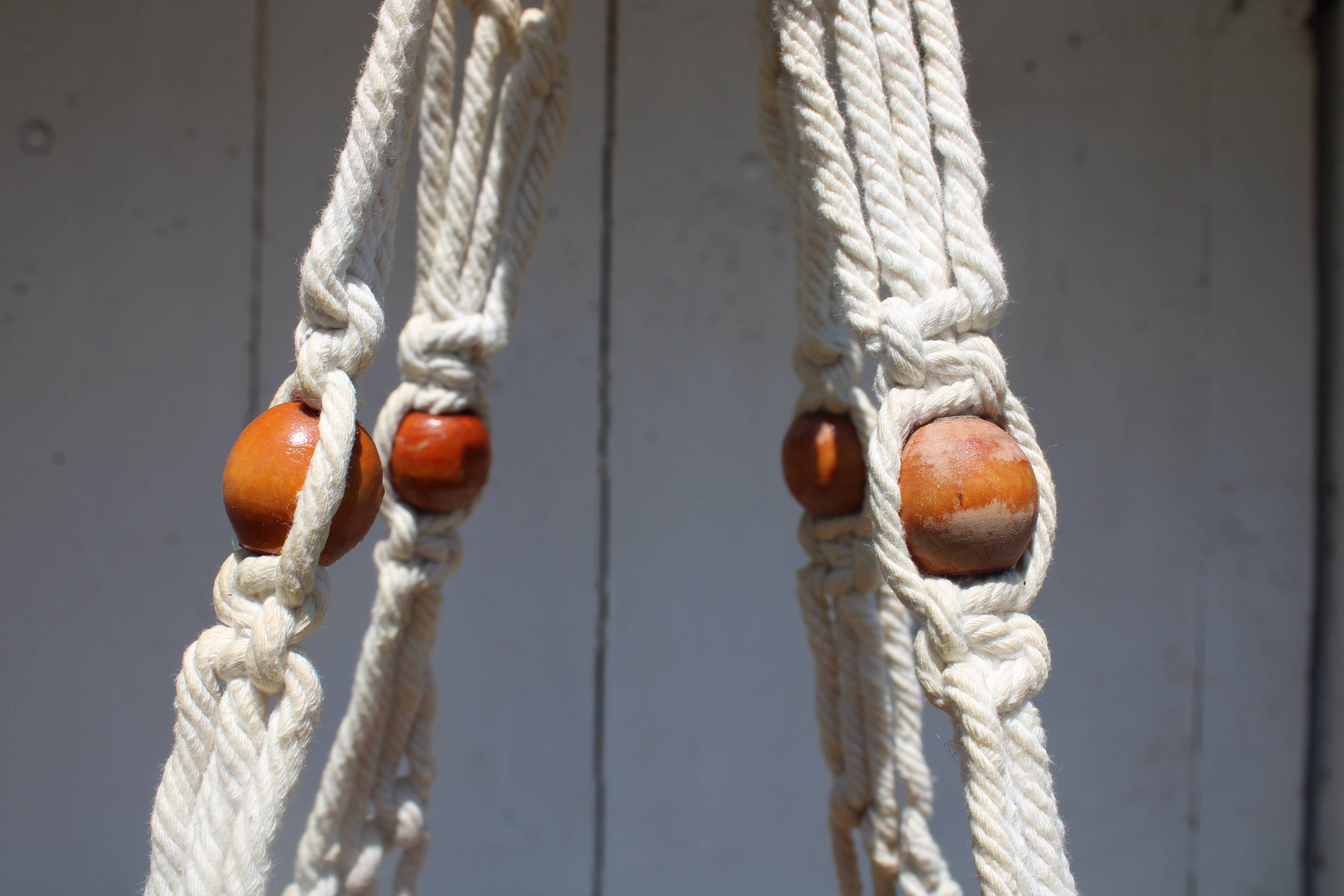 Hanging plant holders in macramé and rattan