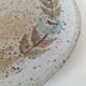 Speckled stoneware plate with floral decoration