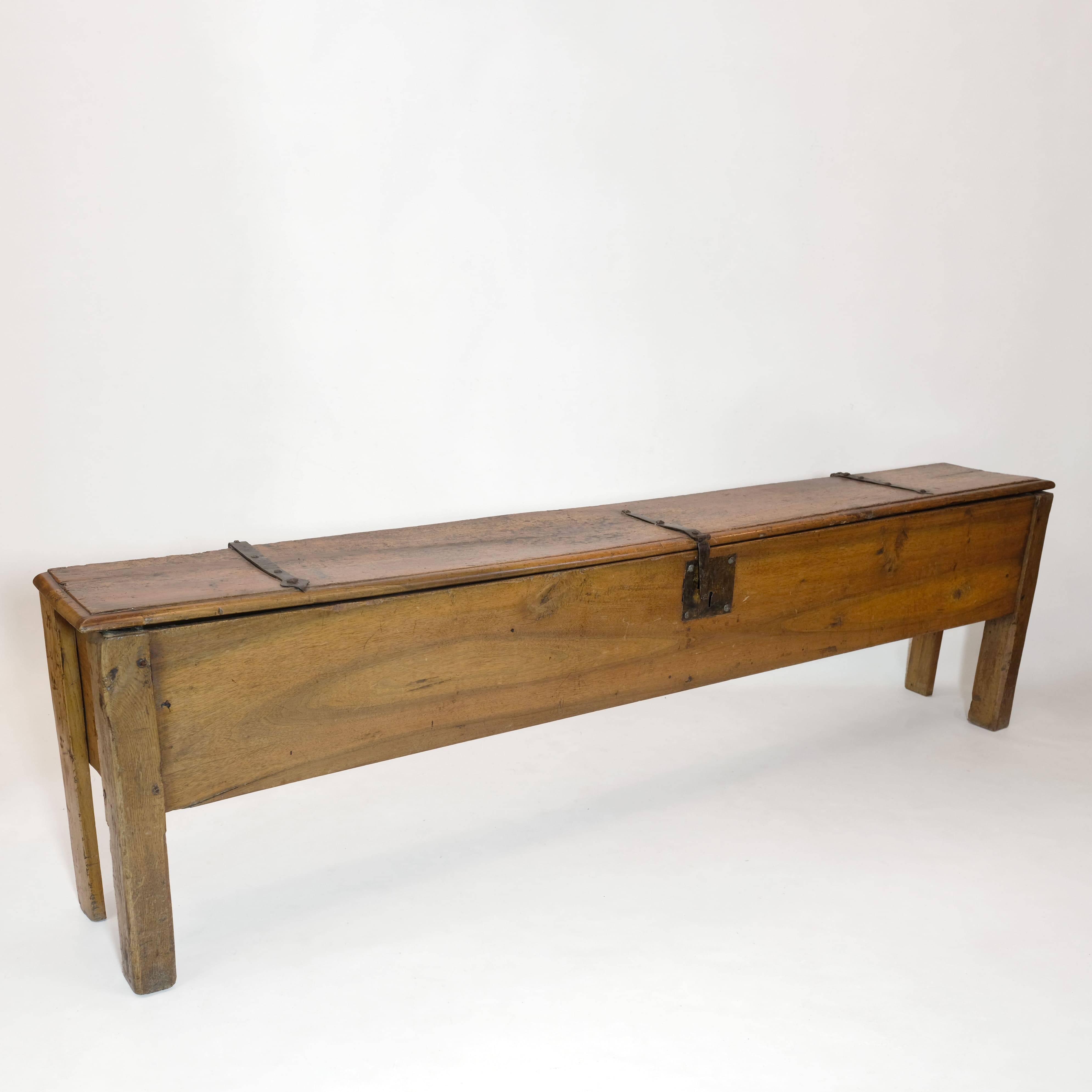Long walnut grain chest forming a bench, 220cm.