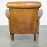 Beautiful and comfortable sheepskin armchair, finished with decorative nailheads