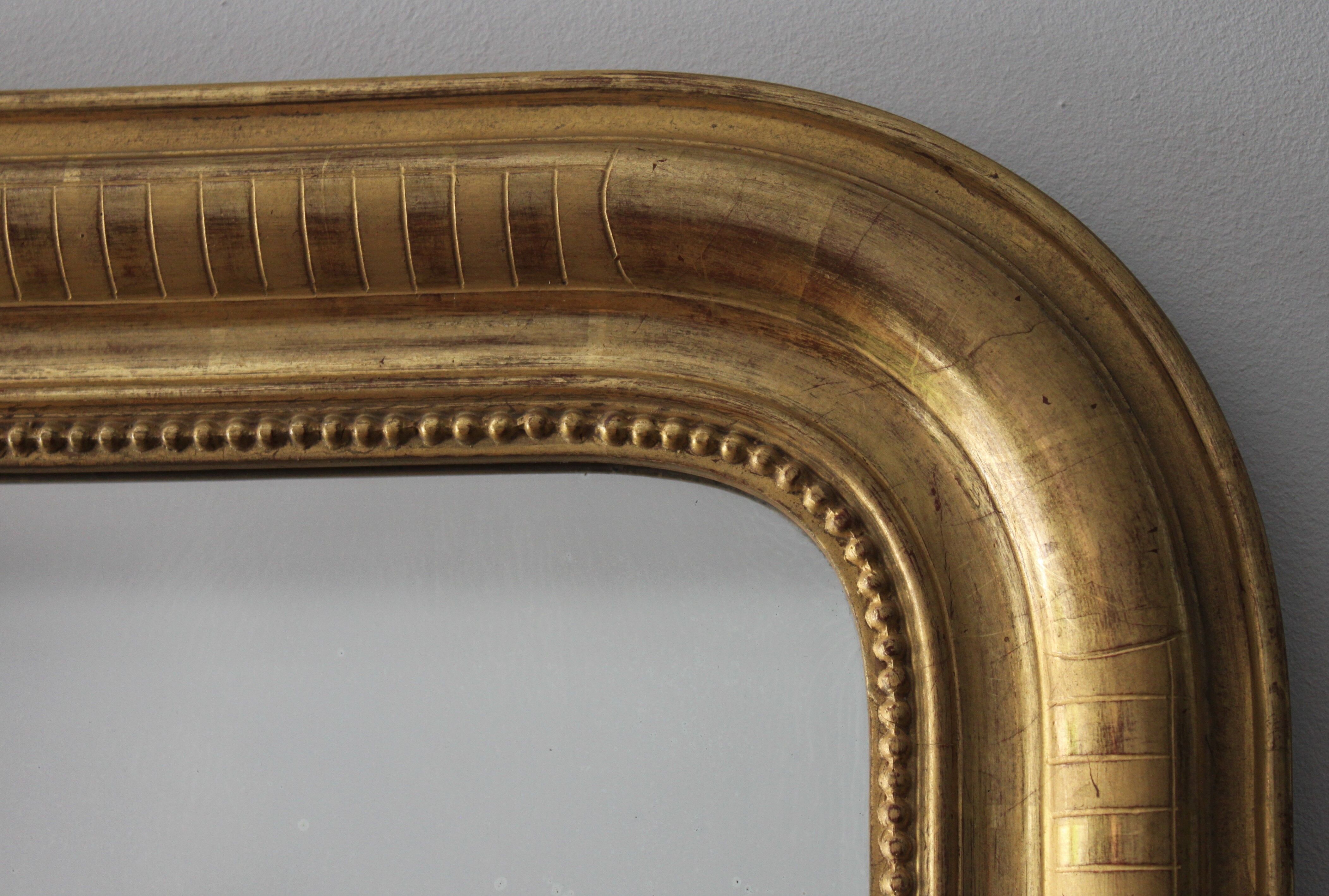 Louis Philippe mirror gilded with gold leaf and original ice dated 1879