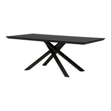 Industrial-style dining table in wood and black metal.