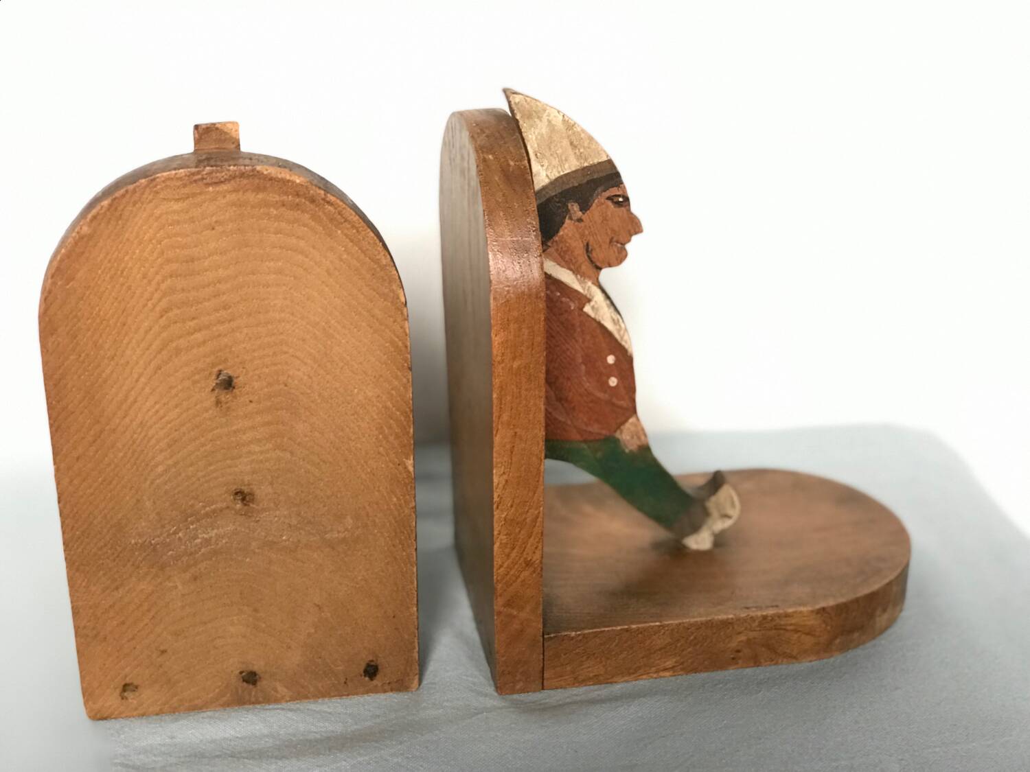 Old wooden bookends with painted characters