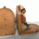 Old wooden bookends with painted characters