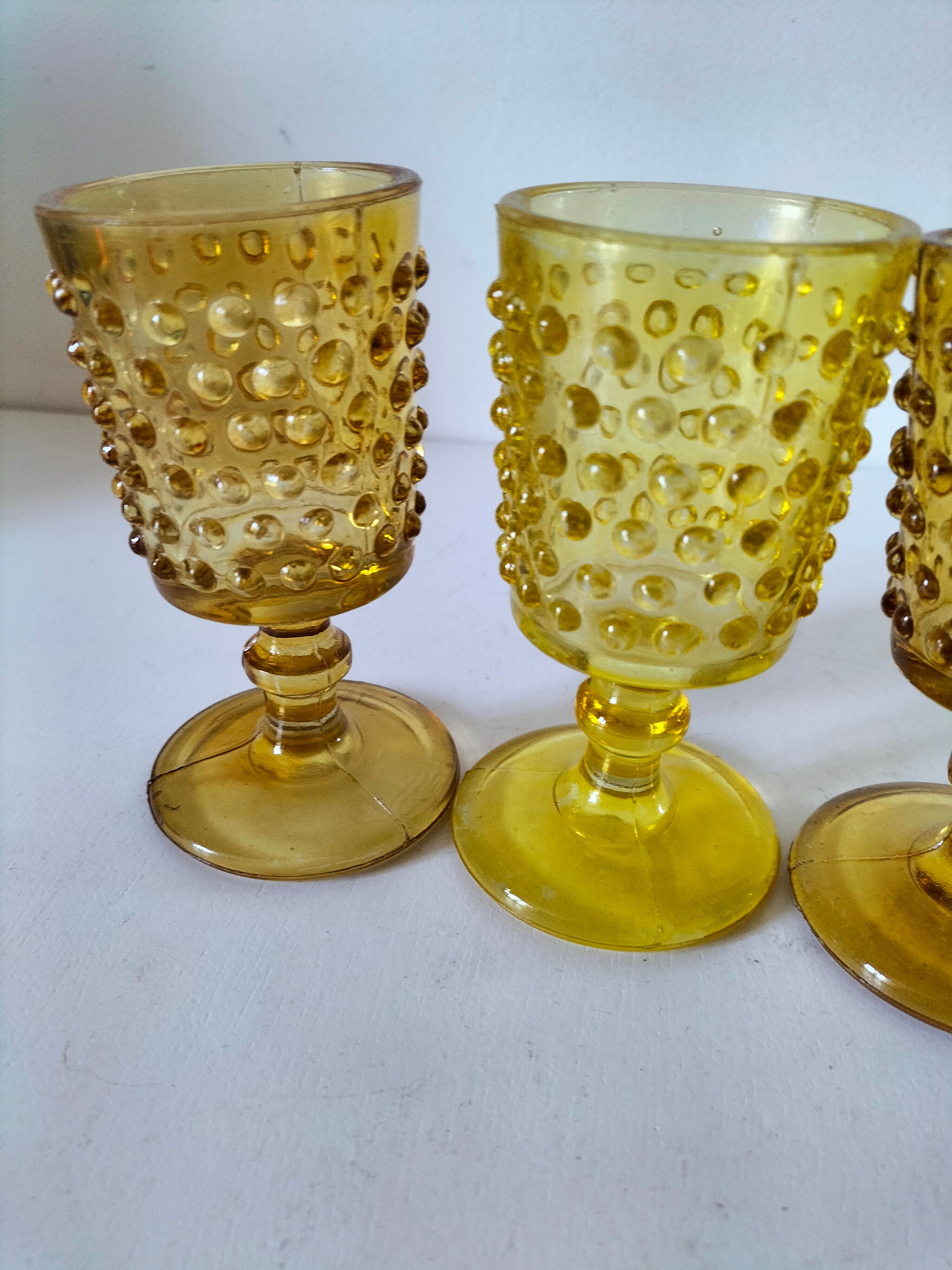 4 vintage stemmed glasses in hobnail glass and smoke colour.