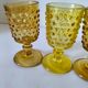 4 vintage stemmed glasses in hobnail glass and smoke colour.