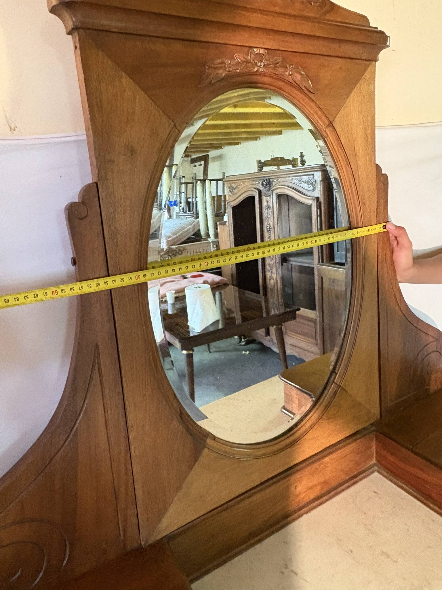 Antique carved wooden dressing table with marble and tilting oval mirror.
